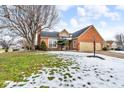 Brick ranch home with attached two-car garage and snowy lawn at 4549 Pepper Ct, Indianapolis, IN 46237