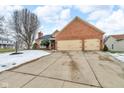 Brick ranch home with attached two-car garage and landscaping at 4549 Pepper Ct, Indianapolis, IN 46237