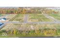 A beautiful aerial view of a quiet neighborhood showcasing expansive vacant lots surrounded by colorful trees at 4976 Elaine Ct, Noblesville, IN 46062