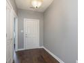 Bright entryway with dark hardwood floors and neutral-colored walls at 5437 Basin Park Dr, Indianapolis, IN 46239