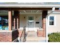 Inviting front porch with brick accents, a white door with wreath, and a well-maintained entrance at 550 Trowbridge St, Indianapolis, IN 46203