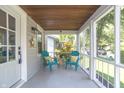 Relaxing screened porch with teal chairs and a view of the backyard at 6118 Evanston Ave, Indianapolis, IN 46220