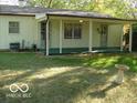 Spacious backyard featuring a covered patio with multiple access points and ample green space at 6508 Meadowlark Dr, Indianapolis, IN 46226
