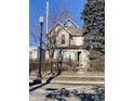 Two-story home needing renovation, boarded windows, and a street view at 724 E 22Nd St, Indianapolis, IN 46202