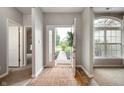 Inviting home foyer boasting neutral paint, natural light, an adjacent carpeted living space and view of the front yard at 8535 Blue Marlin Dr, Indianapolis, IN 46239