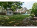 Large backyard with inground pool, shed, and patio at 877 Revere Ct, Greenwood, IN 46142