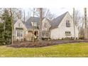 Charming two-story brick home featuring a manicured lawn and mature trees at 9399 Irishmans Run Ln, Zionsville, IN 46077