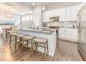 Modern kitchen with white cabinets, granite counters, and stainless steel appliances at 10854 Descanso Dr, Fishers, IN 46038