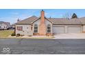 Ranch style home with a brick facade and attached two car garage at 1088 Laurelwood Ln, Greenwood, IN 46142