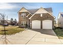 Beautiful two-story brick home featuring a two-car garage, manicured lawn, and a welcoming architectural design at 10917 Hunter Lake Ln, Indianapolis, IN 46239