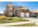 Charming two-story brick home with a well-maintained lawn, a two-car garage and beautiful architectural details at 10917 Hunter Lake Ln, Indianapolis, IN 46239