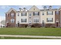 Three-story townhouses showcasing a mix of brick and siding exteriors at 12700 Tamworth Dr, Fishers, IN 46037