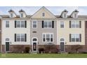 Three-story townhouses with brick and siding, featuring front yards and landscaping at 12700 Tamworth Dr, Fishers, IN 46037
