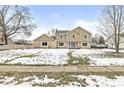 Two-story house with stone and siding accents, partially snow-covered lawn, and driveway at 1271 Spruce Dr, Carmel, IN 46033