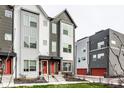Modern townhouses with gray and white siding, red doors, and landscaping at 1738 Alloy Dr, Indianapolis, IN 46201