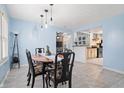 Light blue dining room with a wooden table and six chairs, and view of kitchen at 1749 Sparrow Ave, Indianapolis, IN 46227