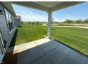 Back patio overlooking a large grassy lawn, perfect for outdoor activities and entertaining in a serene setting at 19438 Astoria Ave, Sheridan, IN 46069