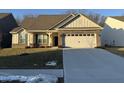 Brick ranch home with a two-car garage and landscaped lawn at 2746 Lanai Ln, Greenwood, IN 46143