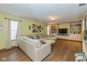 Bright living room featuring built-in bookshelves, neutral decor, and hardwood floors at 442 S Meadow Song Ct, New Palestine, IN 46163
