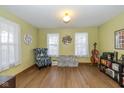 Cozy living room with hardwood floors, natural light, and comfortable seating at 442 S Meadow Song Ct, New Palestine, IN 46163