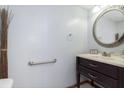 Cozy half bathroom with a dark wood vanity and decorative mirror at 5183 Fairway Dr, Avon, IN 46123