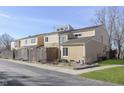 A view of a multi-level home with tan siding and a well-kept yard at 5183 Fairway Dr, Avon, IN 46123