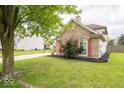Brick home with red shutters and a well-manicured lawn at 57 Sebring Ct, Whiteland, IN 46184