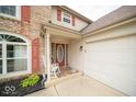 Inviting front porch with rocking chair and stylish doormat at 57 Sebring Ct, Whiteland, IN 46184