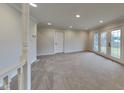 Spacious living room with carpeting and French doors at 5939 Brendonridge S Ct, Indianapolis, IN 46226