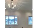 Bright living room with chandelier and large windows at 5939 Brendonridge S Ct, Indianapolis, IN 46226