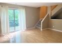 Bright living room features hardwood floors, large windows, and access to a private deck at 6639 N College Ave, Indianapolis, IN 46220