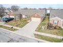 Aerial view of brick ranch home with attached garage and driveway at 7842 Cork Bend Ln, Indianapolis, IN 46239
