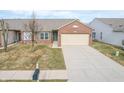 Brick ranch home with attached garage and driveway, front yard view at 7842 Cork Bend Ln, Indianapolis, IN 46239