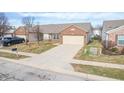 Aerial view of brick ranch home with attached garage and driveway at 7842 Cork Bend Ln, Indianapolis, IN 46239