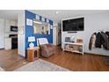 Living room with hardwood floors, a large TV, and a cozy sitting area at 816 E Elbert St, Indianapolis, IN 46227