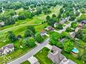 An aerial view of the home surrounded by lush greenery and a golf course at 956 Dorchester Dr, Noblesville, IN 46062