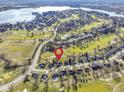 Property's location shown in an aerial view, near a golf course and lake at 956 Dorchester Dr, Noblesville, IN 46062