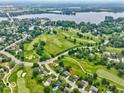 Breathtaking aerial view of a golf course community with a lake and winding roads at 956 Dorchester Dr, Noblesville, IN 46062
