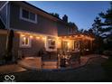 Evening view of a lovely patio with pergola and string lights at 956 Dorchester Dr, Noblesville, IN 46062