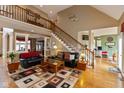 Open concept living room with hardwood floors, high ceilings, and a view to the kitchen at 9711 Sunwood Way, Carmel, IN 46032