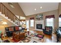Large living room featuring hardwood floors, fireplace and ample natural light at 9711 Sunwood Way, Carmel, IN 46032