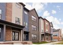 Row of modern townhomes showcasing brick and contrasting siding at 9893 Greenvine Dr, Carmel, IN 46032