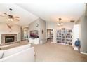 Spacious living room with vaulted ceilings, fireplace, and built-in shelving at 1196 Brittany Cir, Brownsburg, IN 46112