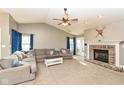 Living room featuring a large sectional sofa and a brick fireplace at 1196 Brittany Cir, Brownsburg, IN 46112