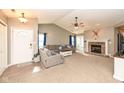 Living room with hardwood floors, fireplace, and neutral color palette at 1196 Brittany Cir, Brownsburg, IN 46112