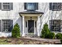 Welcoming front entrance with a stylish door, complemented by manicured shrubs at 128 Wellington Rd, Indianapolis, IN 46260