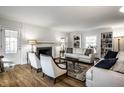 Sun-lit living room with hardwood floors, fireplace, and custom built-in bookshelves at 128 Wellington Rd, Indianapolis, IN 46260