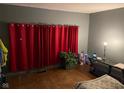 Bedroom with red curtains and wood floors at 1456 Hoyt Ave, Indianapolis, IN 46203