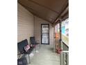 Small front porch with two black chairs at 1456 Hoyt Ave, Indianapolis, IN 46203
