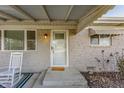 Inviting front porch with rocking chairs, a decorative rug, and a well-lit entryway, enhancing the home's curb appeal at 1505 E 1000 N, Pendleton, IN 46064